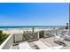 Outdoor deck offers comfortable seating, lounge chairs, and views of the beach and swimming pool at 2000 N Waccamaw Dr., Garden City Beach, SC 29576