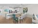 Open dining area with seating for eight and modern kitchen access at 2000 N Waccamaw Dr., Garden City Beach, SC 29576