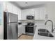 Well-lit kitchen featuring stainless steel appliances, quartz countertops, and ample cabinet space at 2000 N Waccamaw Dr., Garden City Beach, SC 29576