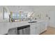 Open-concept kitchen featuring modern appliances, an island bar, and beach views at 2000 N Waccamaw Dr., Garden City Beach, SC 29576