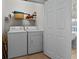 Functional laundry room with washer, dryer, and storage shelving at 2000 N Waccamaw Dr., Garden City Beach, SC 29576