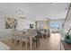 Open-concept living and dining area featuring tile floors and sliders to the outdoor deck and ocean views at 2000 N Waccamaw Dr., Garden City Beach, SC 29576