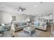Bright living room featuring comfortable sofas, ceiling fan, and tiled floors at 2000 N Waccamaw Dr., Garden City Beach, SC 29576