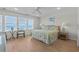 Bedroom featuring a cozy table set by the windows offering ocean views, ceiling fan, and light fixtures at 2000 N Waccamaw Dr., Garden City Beach, SC 29576