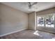Bright bedroom with carpet, ceiling fan, and a window overlooking the parking area at 2005 Silvercrest Dr. # 32-B, Myrtle Beach, SC 29579