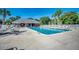 Outdoor community pool surrounded by palm trees and lounge chairs at 2005 Silvercrest Dr. # 32-B, Myrtle Beach, SC 29579