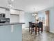 Dining area with tile flooring, marble-top table, four chairs, and bright natural lighting at 206 Balsa Dr., Longs, SC 29568