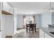 Dining area with a marble-top table, four chairs, light-blue walls, and bright natural lighting at 206 Balsa Dr., Longs, SC 29568