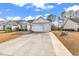 Charming home with a concrete driveway leading to an attached garage, enhanced by a well-manicured lawn at 206 Balsa Dr., Longs, SC 29568