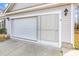 Attached garage featuring a sliding screen door and overhead lighting for added functionality at 206 Balsa Dr., Longs, SC 29568