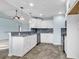 Spacious kitchen with stainless appliances, gray backsplash, white cabinets, and sleek gray flooring at 206 Balsa Dr., Longs, SC 29568