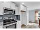 Bright kitchen with stainless steel appliances, tile backsplash, and ample white cabinetry at 206 Balsa Dr., Longs, SC 29568