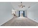 Spacious living area with neutral carpet, high ceilings, and sliding glass doors at 206 Balsa Dr., Longs, SC 29568