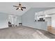 Open-concept living space with a kitchen view, neutral decor, and vaulted ceilings at 206 Balsa Dr., Longs, SC 29568