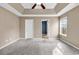 Spacious main bedroom with tray ceiling, plush carpet, and plenty of natural light at 206 Balsa Dr., Longs, SC 29568