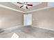 Comfortable carpeted main bedroom featuring a tray ceiling and doorways to the ensuite bathroom at 206 Balsa Dr., Longs, SC 29568