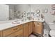 Bright bathroom featuring a long wood vanity, white countertop, and sliding glass shower at 210 Portsmith Dr. # 2, Myrtle Beach, SC 29588