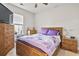 Cozy bedroom features a wooden bed frame, colorful quilt, and matching wooden dressers at 210 Portsmith Dr. # 2, Myrtle Beach, SC 29588