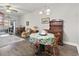 Open-concept dining room featuring hardwood floors, chandelier lighting, and a lovely floral table cover at 210 Portsmith Dr. # 2, Myrtle Beach, SC 29588