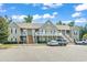 Attractive two-story condo building with private balconies and ample parking space on a sunny day at 210 Portsmith Dr. # 2, Myrtle Beach, SC 29588