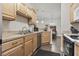 Modern kitchen with a stainless steel dishwasher, wooden cabinets, and a view into the dining area at 210 Portsmith Dr. # 2, Myrtle Beach, SC 29588