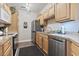 Well-lit kitchen with wooden cabinets, stainless steel appliances, and vinyl flooring for modern living at 210 Portsmith Dr. # 2, Myrtle Beach, SC 29588