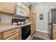 Efficient kitchen with stainless steel appliances, wooden cabinets, and a cozy layout for easy meal prep at 210 Portsmith Dr. # 2, Myrtle Beach, SC 29588