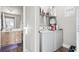 Convenient laundry area with a washer, dryer, shelving, and a view into the bathroom with vanity sink at 210 Portsmith Dr. # 2, Myrtle Beach, SC 29588