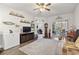 Spacious living room area with a ceiling fan, wood floors, and sliding glass door access to the outdoors at 210 Portsmith Dr. # 2, Myrtle Beach, SC 29588