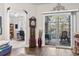 Cozy living room featuring hardwood floors, sliding glass doors to the sunroom, and an antique grandfather clock at 210 Portsmith Dr. # 2, Myrtle Beach, SC 29588