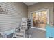 Covered patio featuring a rocking chair and sliding doors to the interior at 210 Portsmith Dr. # 2, Myrtle Beach, SC 29588