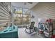 Screened-in porch featuring a ceiling fan and a rocking chair with a forest view at 210 Portsmith Dr. # 2, Myrtle Beach, SC 29588