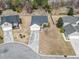 Aerial view of a well-kept single-story home with a driveway, green lawn, and nearby houses in the neighborhood at 2288 Beauclair Ct., Myrtle Beach, SC 29579