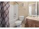 Bathroom with a tub-shower, toilet, and oak vanity at 2288 Beauclair Ct., Myrtle Beach, SC 29579