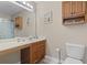 Bathroom featuring a long vanity, oak cabinets, and toilet at 2288 Beauclair Ct., Myrtle Beach, SC 29579
