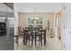 Open dining room has neutral tile floor, stainless steel fridge and access to other rooms at 2288 Beauclair Ct., Myrtle Beach, SC 29579