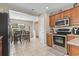 Well-lit kitchen with warm wood cabinets, modern appliances, and an open view to the living areas at 2288 Beauclair Ct., Myrtle Beach, SC 29579