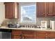 Kitchen featuring wood cabinets, light countertops, stainless steel appliances, and a window over the sink at 2288 Beauclair Ct., Myrtle Beach, SC 29579
