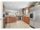 Open kitchen featuring tile floors, wooden cabinets, stainless steel appliances, and a view into the living room at 2288 Beauclair Ct., Myrtle Beach, SC 29579
