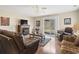 Living room with a fireplace, hardwood floors, and sliding glass doors to the backyard at 2288 Beauclair Ct., Myrtle Beach, SC 29579