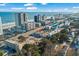 Aerial view of a coastal property featuring a community pool, nearby beach, and surrounding buildings at 2600 S Ocean Blvd. # 101, Myrtle Beach, SC 29577