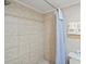 Tiled bathroom featuring a shower and fresh towels at 2600 S Ocean Blvd. # 101, Myrtle Beach, SC 29577