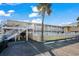Charming two-story building with white railings, a palm tree, and accessible parking spaces at 2600 S Ocean Blvd. # 101, Myrtle Beach, SC 29577