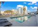 Refreshing swimming pool with lounge chairs and view of surrounding buildings and blue sky at 2600 S Ocean Blvd. # 101, Myrtle Beach, SC 29577