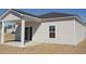 Rear exterior showcasing a covered patio with a sliding glass door leading to the interior at 267 Warner Crossing Way, Loris, SC 29569