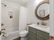 Bright bathroom featuring a shower-tub, round mirror, and a stylish vanity with modern fixtures at 298 Pinehurst Ln. # 10-J, Pawleys Island, SC 29585
