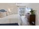 Bright bedroom featuring a comfortable bed, wood floors, natural light and a decorative dresser at 298 Pinehurst Ln. # 10-J, Pawleys Island, SC 29585