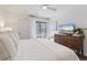 Bright bedroom featuring a comfortable bed, wood floors, natural light and a decorative dresser at 298 Pinehurst Ln. # 10-J, Pawleys Island, SC 29585