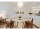 Stylish dining room with a marble table, seating for six, and elegant lighting fixture at 298 Pinehurst Ln. # 10-J, Pawleys Island, SC 29585