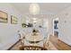 Inviting dining area with a stylish chandelier and a seamless transition to the modern, well-equipped kitchen at 298 Pinehurst Ln. # 10-J, Pawleys Island, SC 29585
